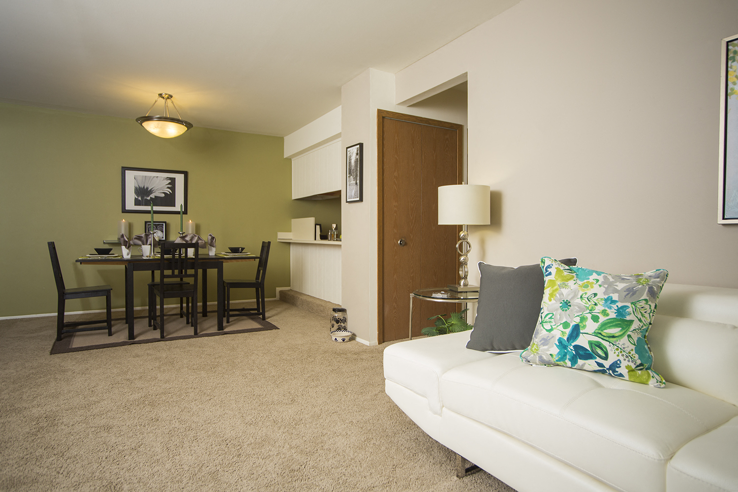 a living room and dining room with a couch and a table